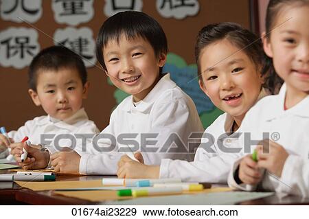 Stock Photo - Students in class smiling at camera. Fotosearch