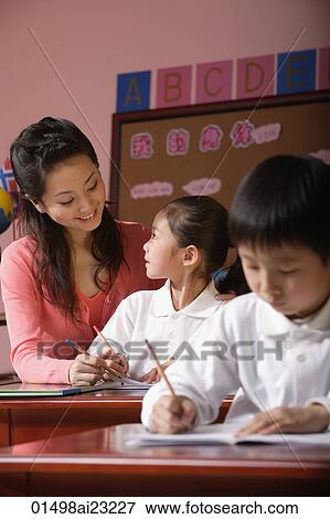 Students in class with teacher looking at schoolgirl View Large Photo Image Stock Photo - Students in class with teacher looking at schoolgirl. Fotosearch