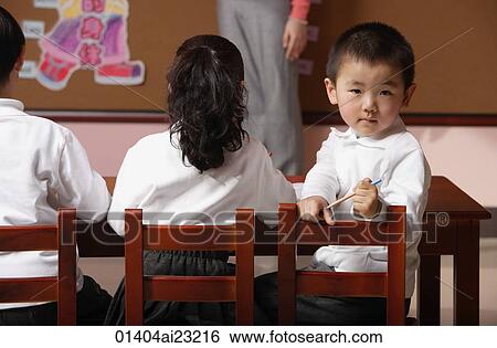Students in class with teacher, schoolboy turning head around looking at camera View Large Photo Image Stock Photograph - Students in class with teacher, schoolboy turning head around looking at camera. Fotosearch