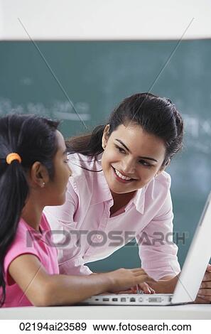 teacher and girl at laptop (vertical) View Large Photo Image Stock Photo - teacher and girl at laptop (vertical). Fotosearch