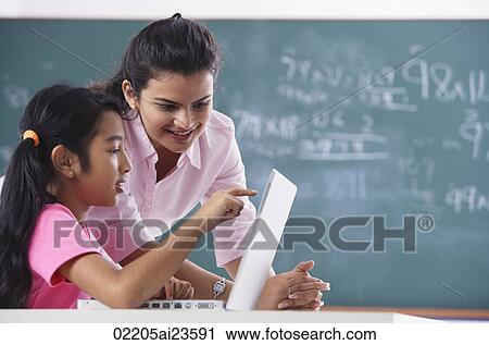 teacher and student at laptop, girl pointing at screen View Large Photo Image Stock Image - teacher and student at laptop, girl pointing at screen. Fotosearch