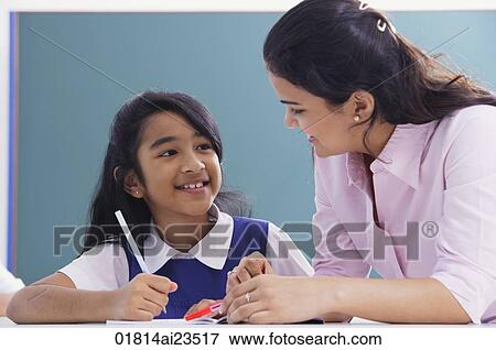 teacher and student smile at each other View Large Photo Image Stock Photo - teacher and student smile at each other. Fotosearch