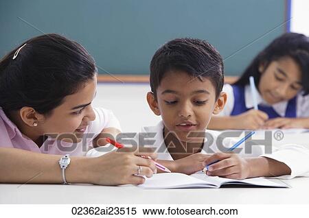teacher helps student with schoolwork View Large Photo Image Stock Photography - teacher helps student with schoolwork. Fotosearch