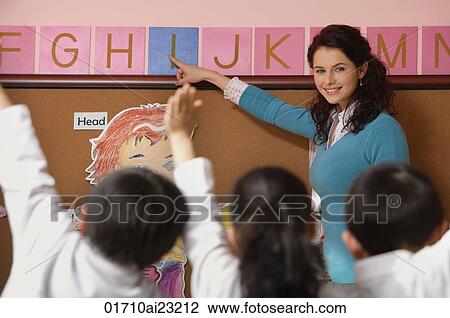 Teacher teaching alphabet in class View Large Photo Image Stock Image - Teacher teaching alphabet in class. Fotosearch
