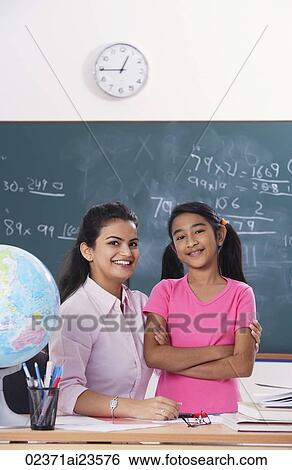 teacher with arm around student, both smiling at camera View Large Photo Image Stock Photograph - teacher with arm around student, both smiling at camera. Fotosearch
