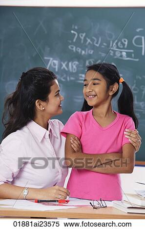 Stock Photography - teacher with arm around student, both looking at each other. Fotosearch
