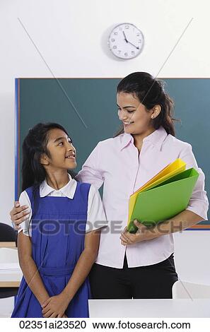 Stock Image - teacher with arm around student. Fotosearch
