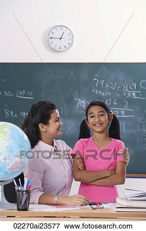 Stock Photo - teacher with arm around student, student looking at camera. Fotosearch
