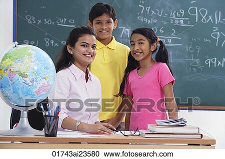 Stock Image - teacher with two students, all smiling at camera. Fotosearch
