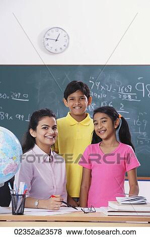 Stock Photo - teacher with two students, all smiling at camera. Fotosearch