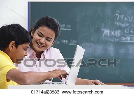 teacher working with student at laptop View Large Photo Image Stock Image - teacher working with student at laptop. Fotosearch
