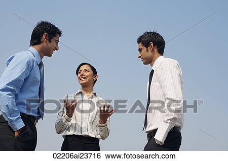 Stock Photograph - three business colleagues, conversing. Fotosearch