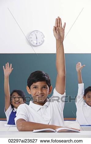 three students raise hands, boy in center View Large Photo Image Stock Photo - three students raise hands, boy in center. Fotosearch