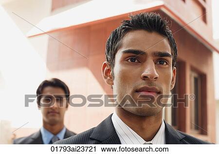 Stock Image - two business men, facing camera (close up). Fotosearch