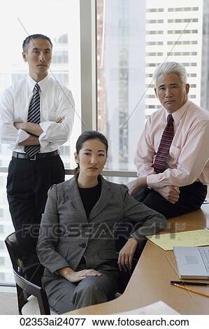 two businessmen, one businesswoman View Large Photo Image Stock Photo - two businessmen, one businesswoman. Fotosearch