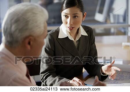 two colleagues discussing View Large Photo Image Stock Image - two colleagues discussing. Fotosearch