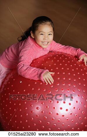 Two girls leaning on balls, looking at each other View Large Photo Image Stock Image - Two girls leaning on balls, looking at each other. Fotosearch