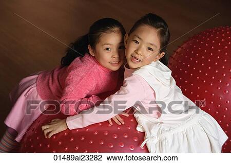 Two girls smiling at camera View Large Photo Image Stock Image - Two girls smiling at camera. Fotosearch