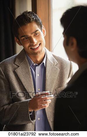 two male colleagues talking (vertical) View Large Photo Image Stock Image - two male colleagues talking (vertical). Fotosearch