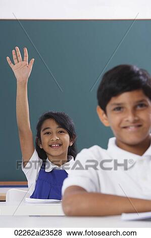 Stock Photo - two students, girl raises hand. Fotosearch
