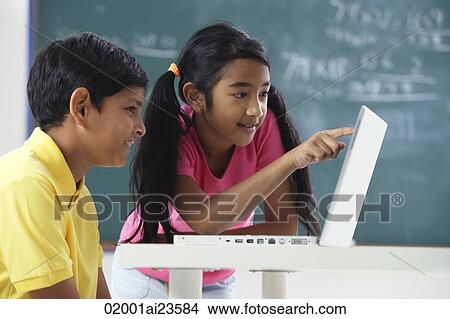 two students working at laptop View Large Photo Image Picture - two students working at laptop. Fotosearch