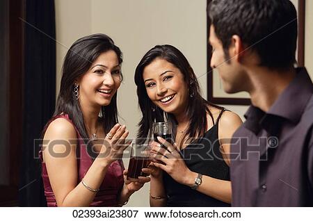 Stock Photo - two woman, one man at a party. Fotosearch