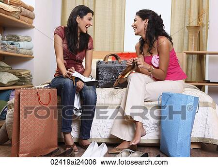 two women sitting on bed View Large Photo Image Stock Photograph - two women sitting on bed. Fotosearch