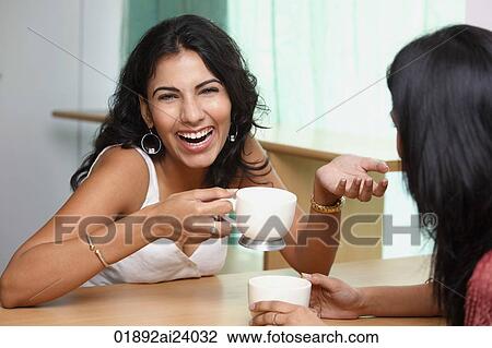 two young woman having coffee View Large Photo Image Stock Image - two young woman having coffee. Fotosearch