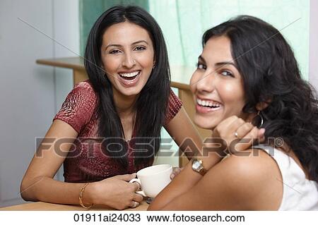 two young woman having coffee View Large Photo Image Stock Image - two young woman having coffee. Fotosearch