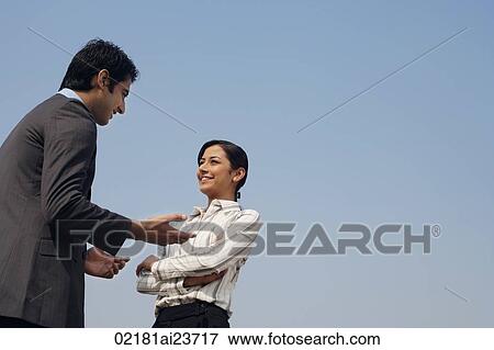 Stock Photo - woman and man discussing business (horizontal). Fotosearch