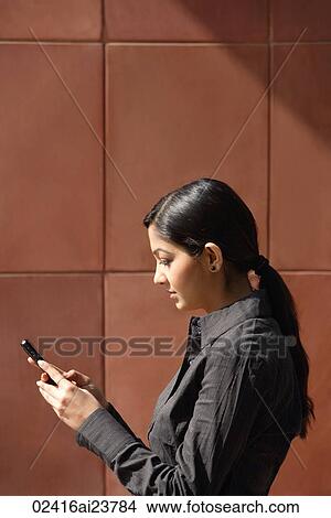 woman reading messages (vertical) View Large Photo Image Picture - woman reading messages (vertical). Fotosearch
