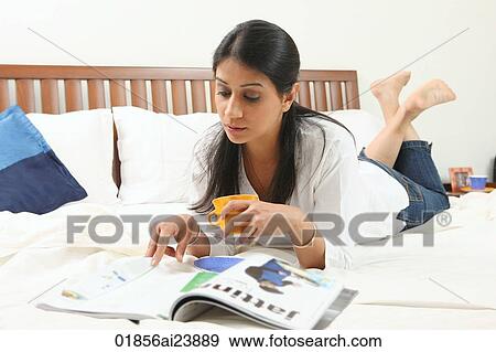 Woman reading on bed View Large Photo Image Stock Photo - Woman reading on bed. Fotosearch