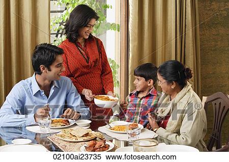 woman serves dinner to her family View Large Photo Image Stock Photography - woman serves dinner to her family. Fotosearch