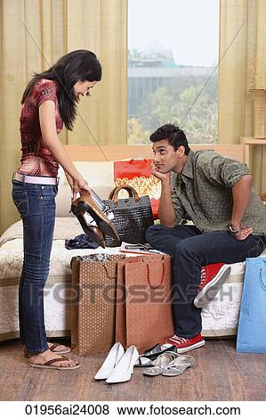 Stock Photo - woman showing boyfriend shopping. Fotosearch