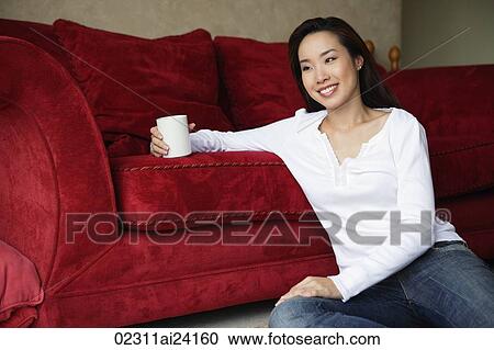 woman sitting on floor holding coffee cup View Large Photo Image Stock Image - woman sitting on floor holding coffee cup. Fotosearch
