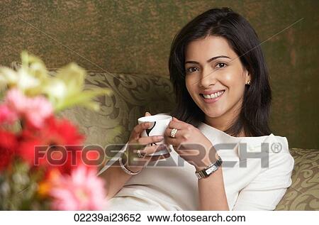 woman smiles holding cup of tea View Large Photo Image Stock Image - woman smiles holding cup of tea. Fotosearch