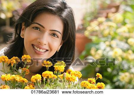 Stock Image - woman with flowers (horizontal). Fotosearch