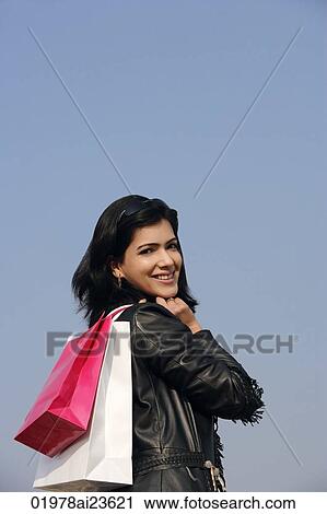 woman with shopping bags over shoulder View Large Photo Image Stock Image - woman with shopping bags over shoulder. Fotosearch