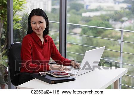 woman working at desk View Large Photo Image Stock Photo - woman working at desk. Fotosearch