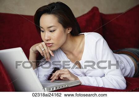 woman working on laptop on couch View Large Photo Image Stock Image - woman working on laptop on couch. Fotosearch