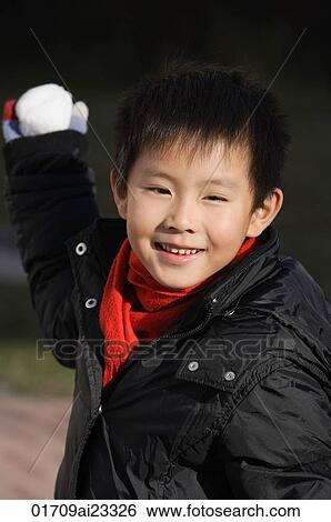 Stock Photograph - Young boy about to throw snowball. Fotosearch