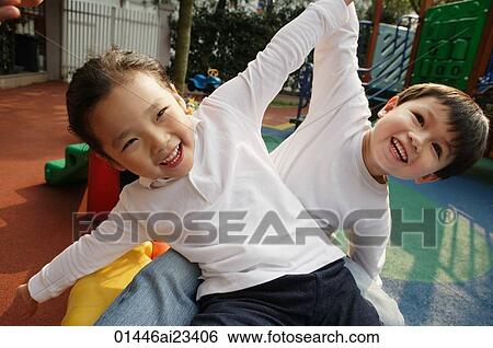 Young boy and girl playing in playground View Large Photo Image Stock Photograph - Young boy and girl playing in playground. Fotosearch