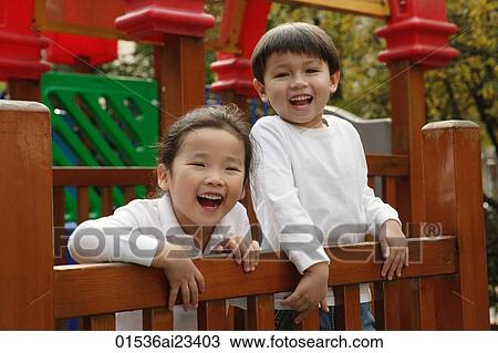 Young boy and girl playing in playground, looking at camera View Large Photo Image Stock Image - Young boy and girl playing in playground, looking at camera. Fotosearch