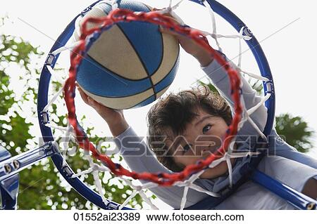 Young boy shooting basketball hoop View Large Photo Image Stock Photo - Young boy shooting basketball hoop. Fotosearch
