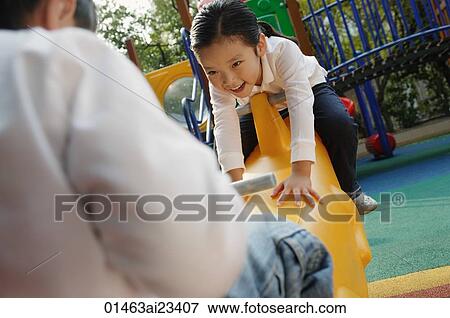 Stock Photo - Young children playing in playground. Fotosearch
