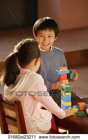 Stock Image - Young children playing with building blocks. Fotosearch