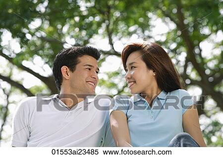 Stock Photography - Young couple at the park. Fotosearch