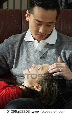 Young couple looking lovingly at each other View Large Photo Image Stock Image - Young couple looking lovingly at each other. Fotosearch