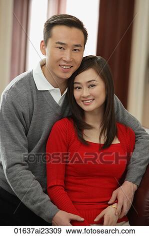 Young couple smiling at camera View Large Photo Image Stock Photo - Young couple smiling at camera. Fotosearch