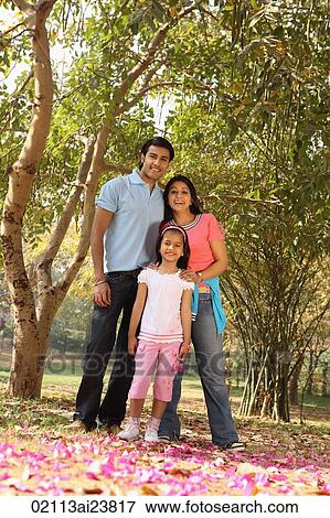 Young family in grove of trees View Large Photo Image Stock Photo - Young family in grove of trees. Fotosearch